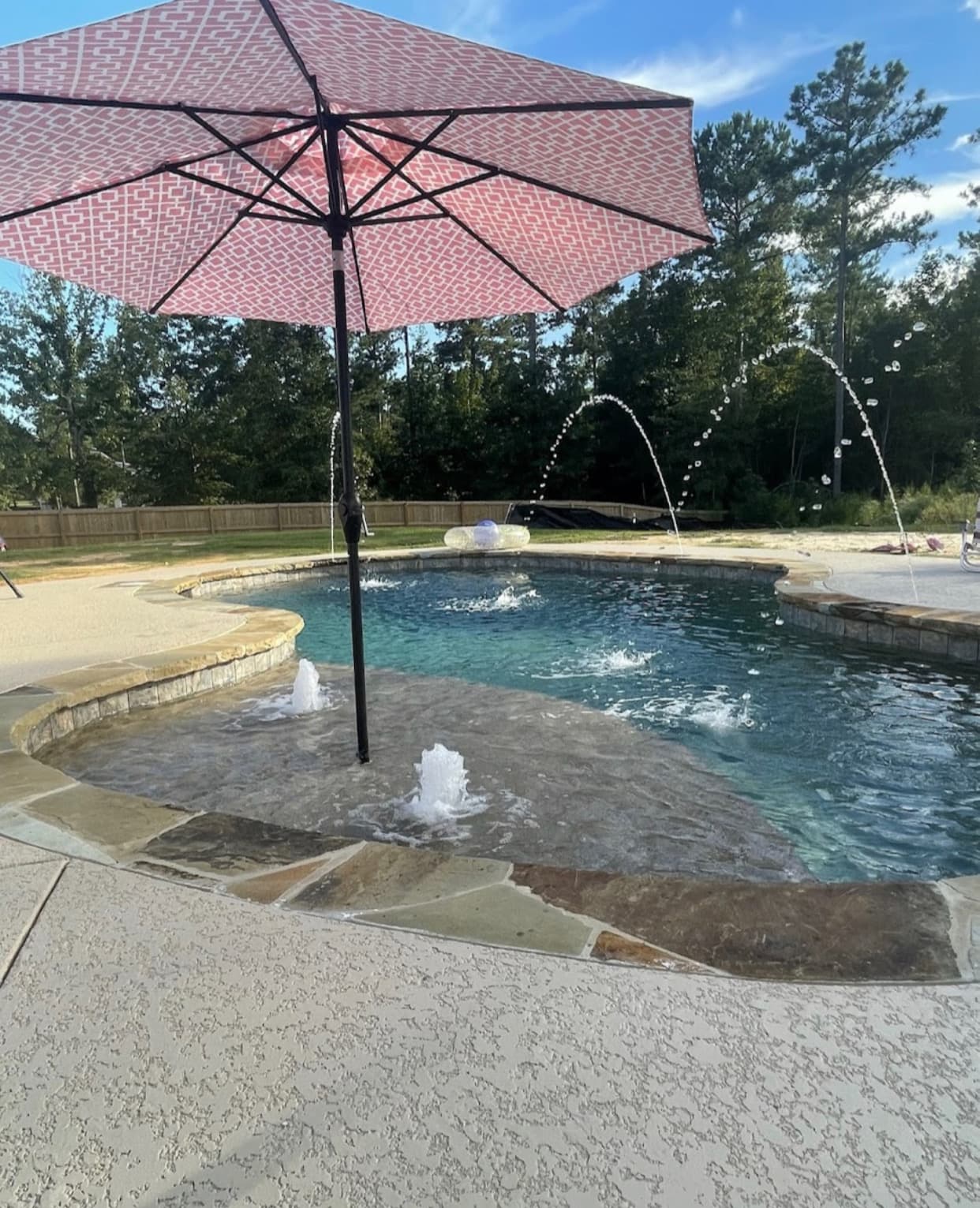 Deck jets arcing into a custom pool with dramatic visual movement.