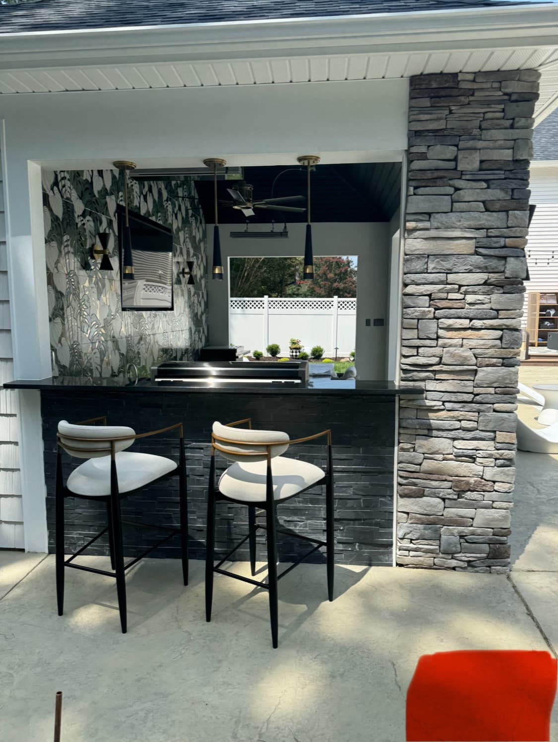 Outdoor kitchen and bar built into a custom patio layout.