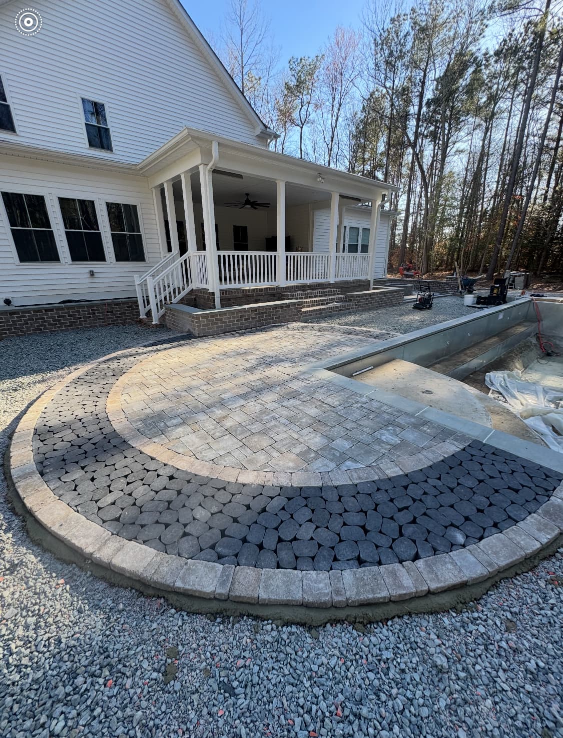 Circular paver patio pattern connecting the home to the pool area.