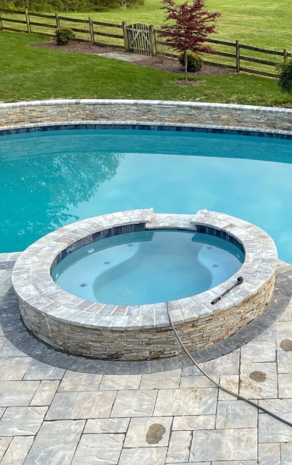 Custom pool project with surrounding stone deck.