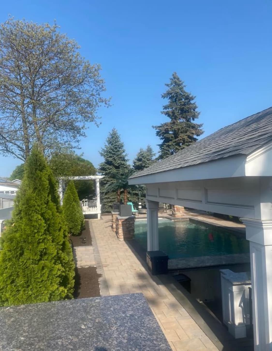 Commercial-style pool amenity area with shade and gathering space.