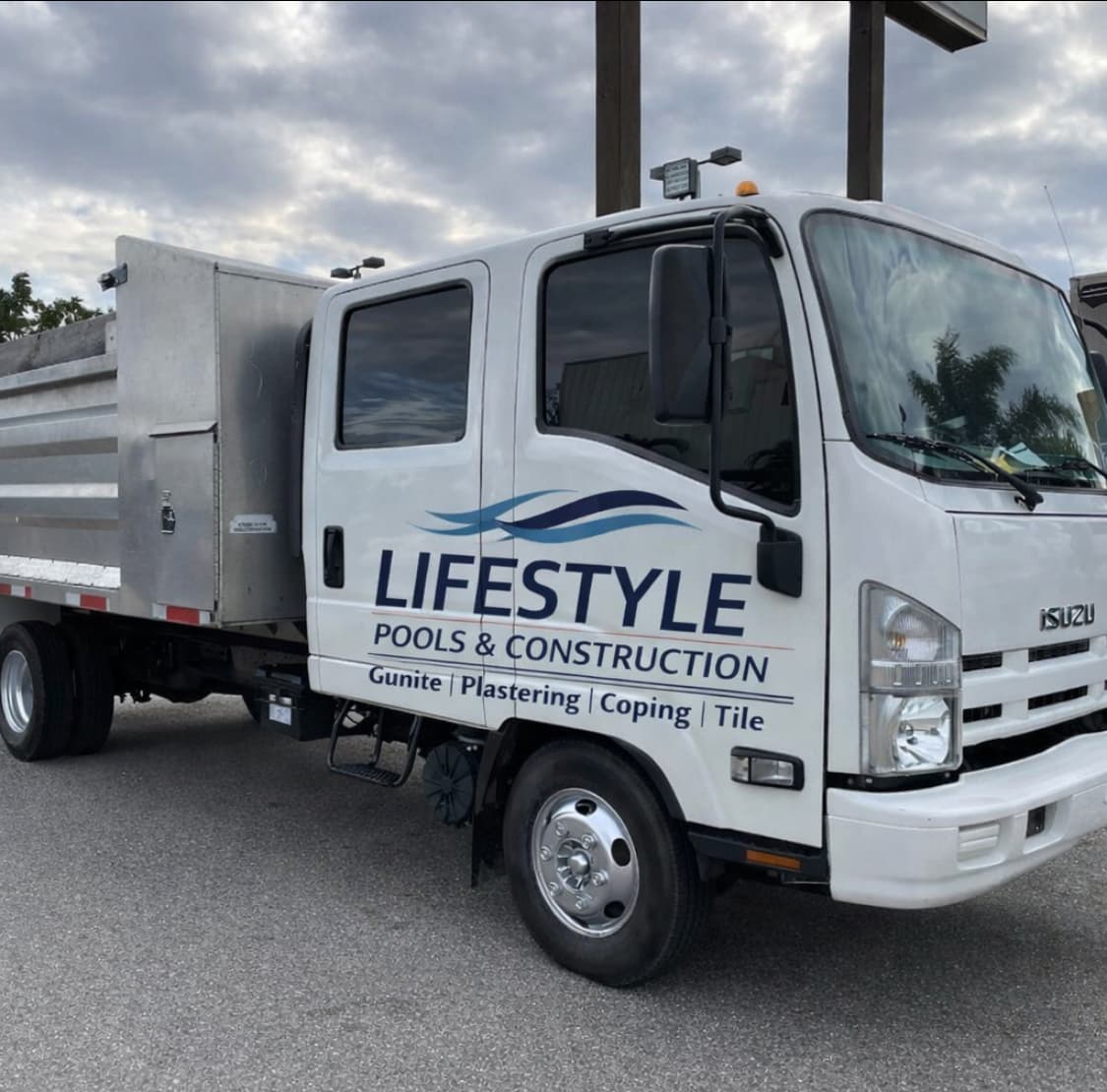 Lifestyle Pools & Construction crew cab work truck with company branding.