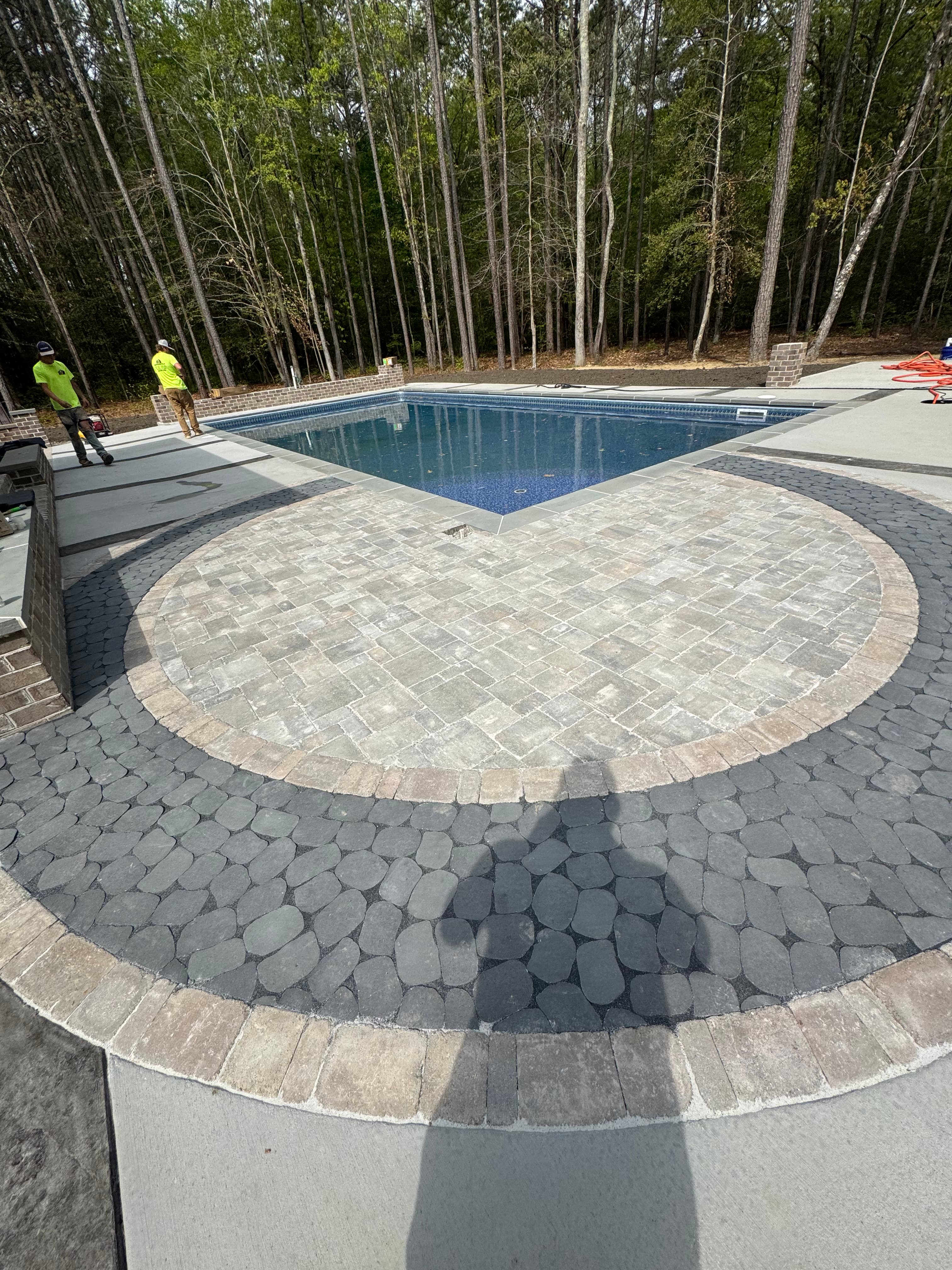 Paver hardscape installation surrounding a commercial pool deck.