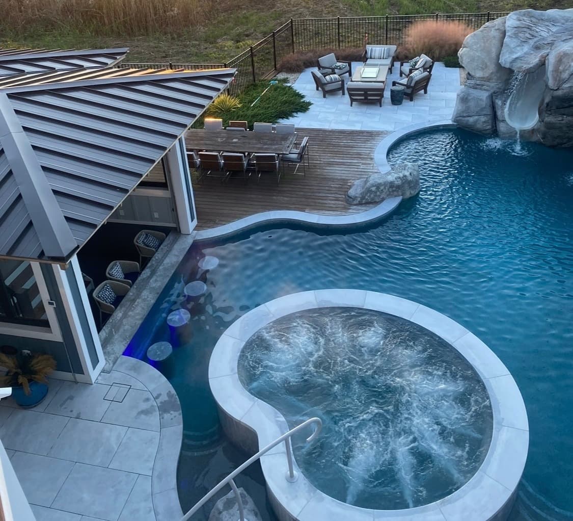 Custom pool with large waterfall feature and grotto styling.