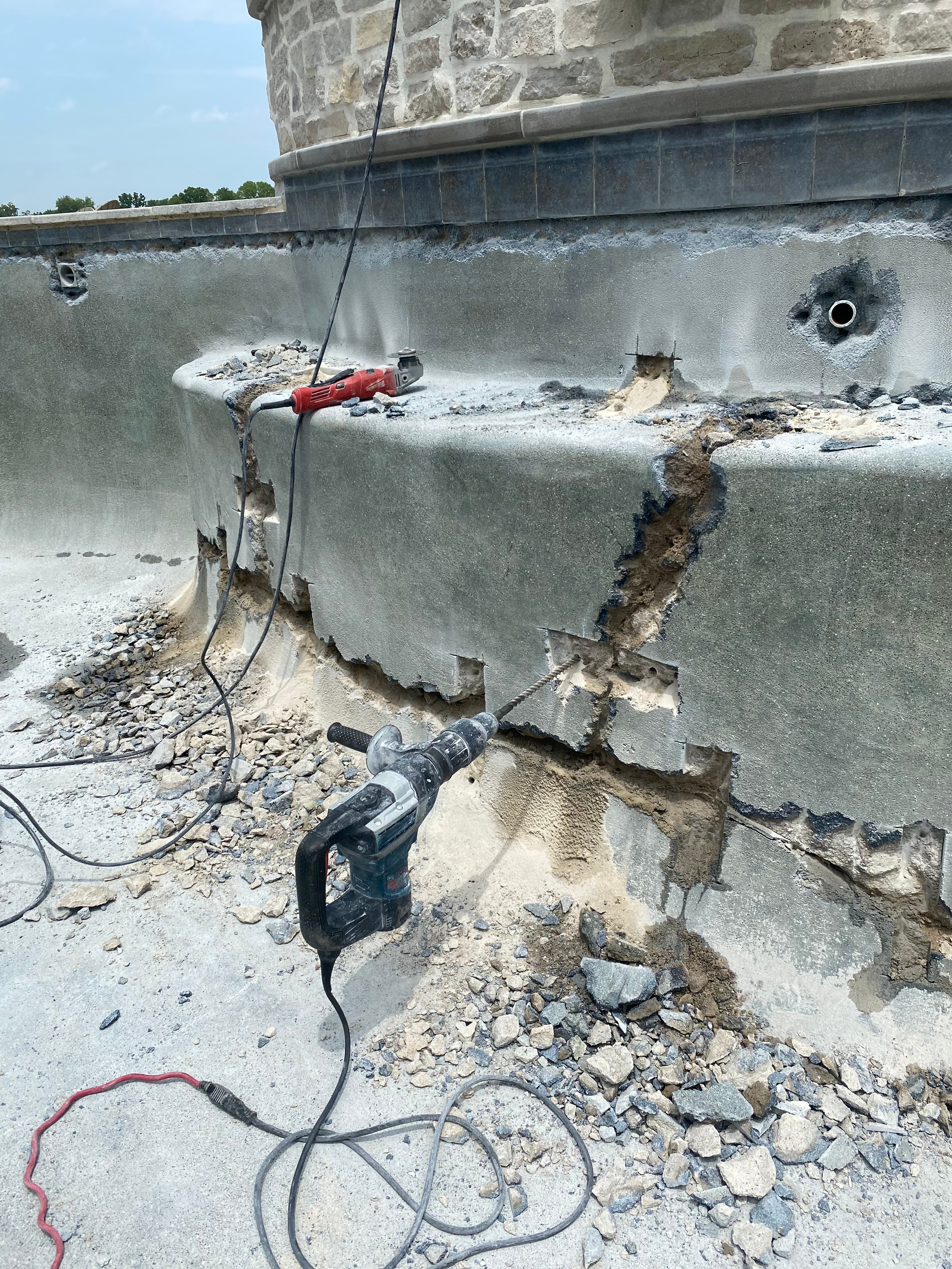 Structural demolition and repair on a commercial pool wall.